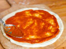 Cooking Class - Handmade Custom Pizza 101: adding tomato marinara to pizza