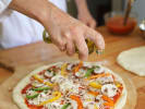 Cooking Class - Mastering Pizza Dough: adding topping to pizza