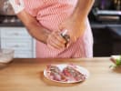 Cooking Class - A Celebration of Culinary Color in South Bay & Peninsula: chef in apron seasoning raw meat in home kitchen