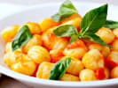 Cooking Class - Handmade Gnocchi & Marinara Workshop in Portland, OR: basil garnished elegant gnocchi in tomato sauce ona white plate