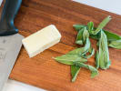 Online Cooking Class - Homemade Gnocchi and Chocolate Torrone: butter and fresh sage on a wooden cutting board