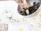 Cooking Class - Healthy Mediterranean Favorites in Chicago: chef adding mixed greens to salad plate