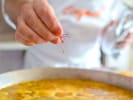 Cooking Class - Flavors of Spain in DC: chef adding saffron to paella