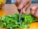 Cooking Class - Homemade Curry Curation: chef chopping cilantro on a wooden cutting board