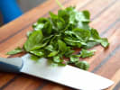Cooking Class - Hearty Vegan Feast: chef chopping spinach