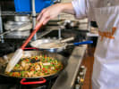 Team Building Cooking Class - Spanish Paella Showcase in Downtown San Diego: chef cooking paella in a pan