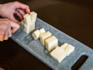 Online Couples Cooking Class - Charcuterie Boards 101: chef cutting artisanal cheese