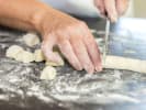 Team Building Cooking Class - Gnocchi Perfection: chef cutting dough into gnocchi