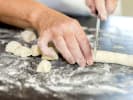 Cooking Class - Mastery of Italian Gnocchi in Marin County: chef cutting dough into gnocchi