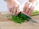 Cooking Class - Traditional Japanese Dishes: chef cutting green onions on a wooden cutting board.jpg