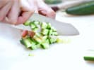 chef dicing cucumbers