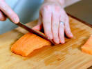 Cooking Class - Protein Filleting and Trimming Techniques in Boston: chef fileting raw salmon