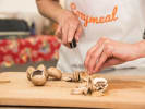 Cooking Class - Hunger is Coming: chef in Cozymeal apron cutting mushrooms