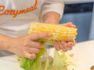 Cooking Class - Plant-Based Party Bites in Santa Monica: chef in Cozymeal apron holding a corn