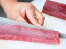 Team Building Cooking Class - Speciality Maki and More in DC: chef making sushi with sliced tuna