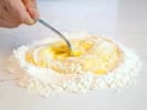 Cooking Class - Classic Pasta-Making Workshop: chef mixing flour and eggs to make pasta dough