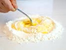 Cooking Class - Classic Fare From Little Italy: chef mixing flour and eggs to make pasta dough