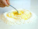 Cooking Class - Italian-Inspired Favorites: chef mixing flour and eggs to make pasta dough