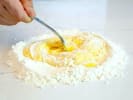 Cooking Class - Fresh Pasta From Scratch in Manhattan: chef mixing flour and eggs to make pasta dough