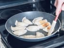 Cooking Class - Elevated Asian Dim Sum: chef pan frying gyoza