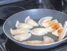 Cooking Class - Modern Asian Comfort Food in Austin: chef pan frying gyoza