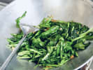 Cooking Class - Essential Vegan Thai in Austin: chef sauteing spinach