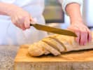 Cooking Class - Introduction to French Cooking: chef slicing a baguette