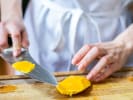 Cooking Class - Sweet and Savory Thai Cuisine in Austin: chef slicing a mango