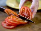 Online Cooking Class - Fast Food Favorites Gone Vegan: chef slicing a tomato