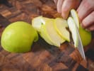Online Cooking Class - Seafood Paella and Sangria: chef slicing an apple