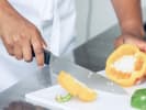 Cooking Class - Global Vegan Cuisine in San Jose: chef slicing fresh bell peppers