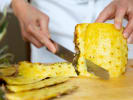 Cooking Class - Traditional Thai Feast: chef slicing fresh pineapple