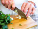 Online Cooking Class - Classic Greek Spanakopita: chef slicing garlic