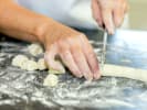 Team Building Cooking Class - Gourmet Italian-American Cuisine in Philadelphia: chef slicing gnocchi dough