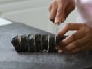 Online Sushi Making Class - Vegan Poke Bowls and Sushi Rolls: chef slicing maki sushi rolls