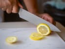 Online Mixology Class - Deliciously Spooky Cocktails: chef slicing meyer lemons