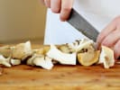 Team Building Cooking Class - Asian Cuisine Cooking Competition in Boston Proper: chef slicing mushrooms