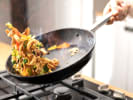 Cooking Class - Fast and Furious Weeknight Meals in San Jose: chef stir frying meat and vegetables