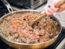 Cooking Class - Authentic Pasta-Making Techniques in NYC: chef stirring bolognese sauce