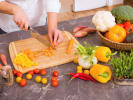 Cooking Class - 5-Day Foodie Fun Kids: Global Cooking and Creativity in Downtown Dallas: child cutting vegetables in the kitchen on a wooden board