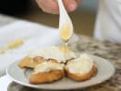 Cooking Class - Ricotta Everything: close up of chef drizzling honey over crostini topped with ricotta cheese