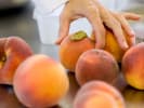 Cooking Class - Vegan Southern Classics: close up of choosing fresh peaches
