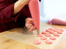 Cooking Class - Bake Your Own French Macarons in Boston Proper: piping pink berry macaron batter to form macaron shells