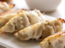 Cooking Class - Chinese Dumpling-Making Essentials in Jacksonville: gyoza dumplings with crust on a black plate