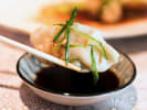 Cooking Class - Classic Dim Sum Dumplings in Portland, OR: dumplings being dipped into soy sauce