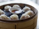 Cooking Class - Craft Chinese Dumplings From Scratch in Baltimore: dumplings in a steamer with dipping sauce