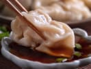Cooking Class - Craft Chinese Dumplings From Scratch in Baltimore: dipping steamed dumpling in a soy sauce