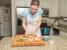 Cooking Class - Asian Dumplings for Beginners in San Antonio: female chef in Cozymeal apron making pork filled Asian dumplings