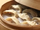 Team Building Cooking Class - Team Dumpling Showdown: dumplings in a steamer with scallions