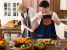 Team Building Cooking Class - Team Dumpling Showdown: helping to put on an apron